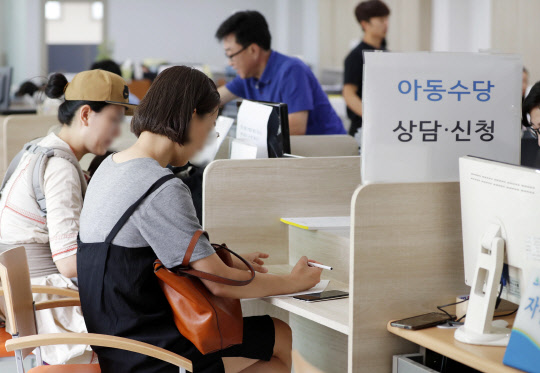 20일 서울 송파구 오금동 주민자치센터에서 보호자들이 오는 9월부터 아동 1명당 월 10만원씩 지급되는 아동수당을 신청하고 있다. 올해 처음 시행되는 아동수당은 만 6세미만 아동에게 수급아동기구의 경제적 수준이 2인 이상 전체 가구의 100분의 90 수준 이하인 경우에 1인당 월 10만원을 지급한다.